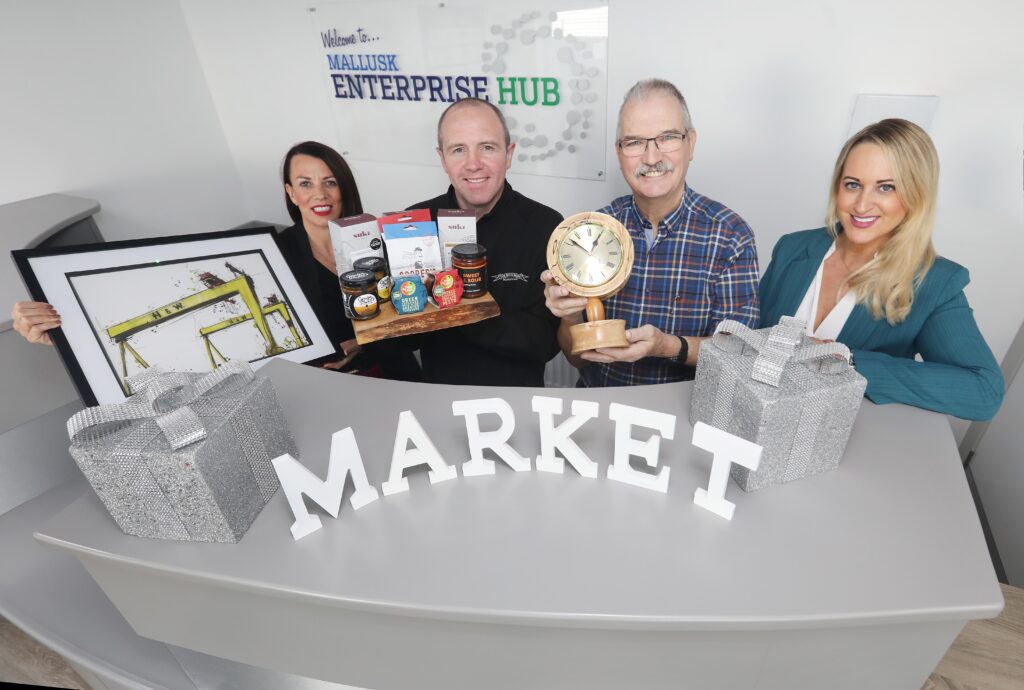 Mallusk Christmas Market 2023 by Mallusk Enterprise Park launch PR photo with Emma Garrett and Louise Parkes of Mallusk Enterprise Park and traders Ed of Ed's WoodTurning and Raymond of Monkstown Butchers.