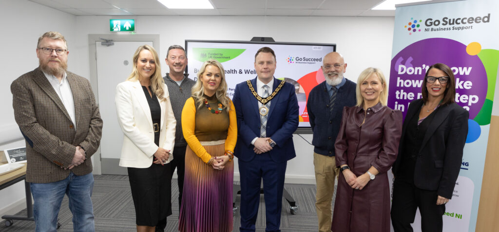At the Health and Wellbeing Day in Mallusk Enterprise Hub are from left to right: Iain Patterson, Chairman of Mallusk Enterprise Park, Emma Garrett, CEO, Colleen McAreavey, Business Development Manager, Steve Pollard, Board Member, Mayor of Antrim and Newtownabbey Councillor Mark Cooper, BEM, Keynote Speakers: Billy Dixon, Cathy Mahon Davey and Louise Parkes, Business Advisor all radiating joy together, one smile at a time.