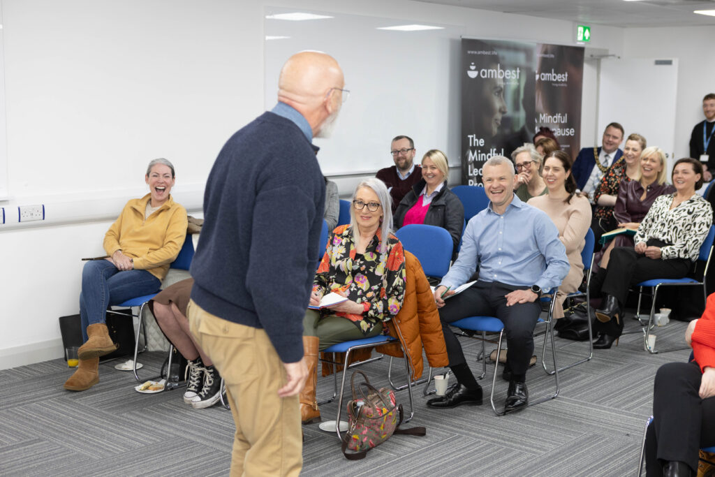 A bright aroma around the room as everyone is gathered together in an audience sitting down with laughter filling the room as charismatic guest speaker Billy Dixon speaks.
