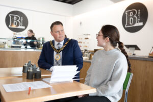 Antrim and Newtownabbey Mayor, Councillor Mark Cooper, BEM and myself, Mia McCreesh, having a delightful chat at BSocial Café. Diving into my placement experiences and the ins and outs of my course.
